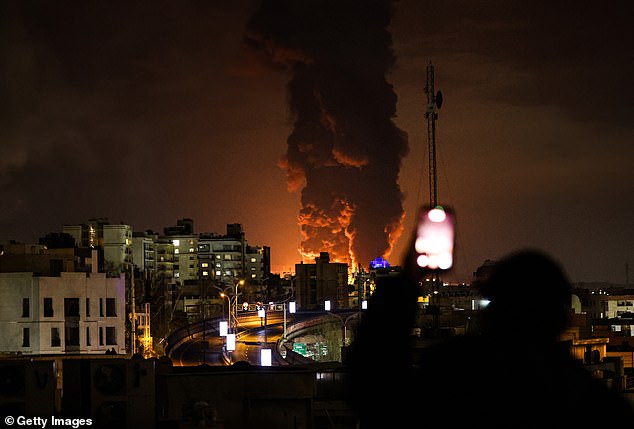 A large plume of smoke rises over Tehran after explosions were reported in the city during the night on March 7