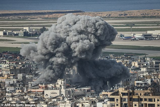 Smoke rises from the site of an Israeli airstrike that targeted the Al Lailaki neighborhood in Beirut's southern suburbs, with the city's international airport visible in the background, on March 4