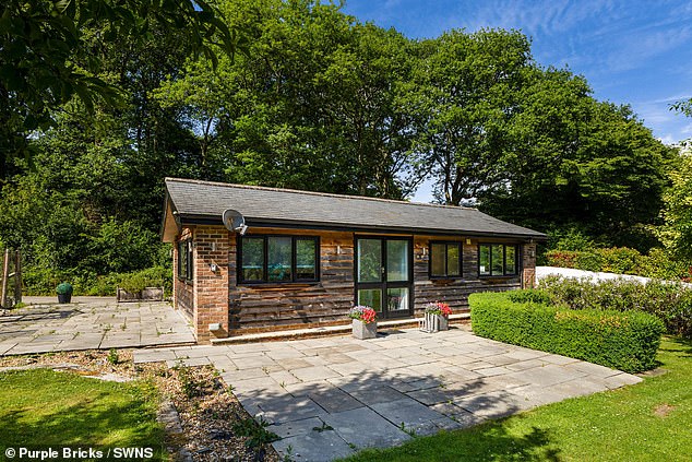 There are also several outbuildings included on the property, like this cottage and a dehumidified car garage