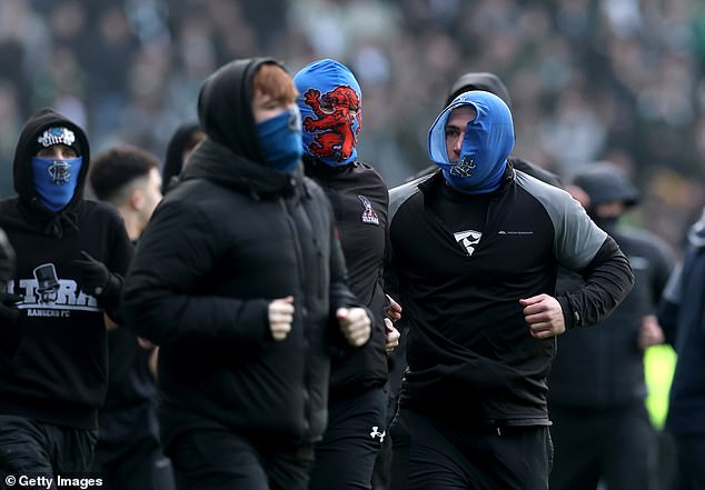 A number of Rangers fans wore blue balaclavas as they entered the field to confront Celtic supporters