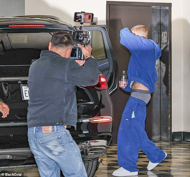 After entering a waiting vehicle, Justin chucked a water bottle at photographers who bombarded the couple with flashbulbs, according to TMZ