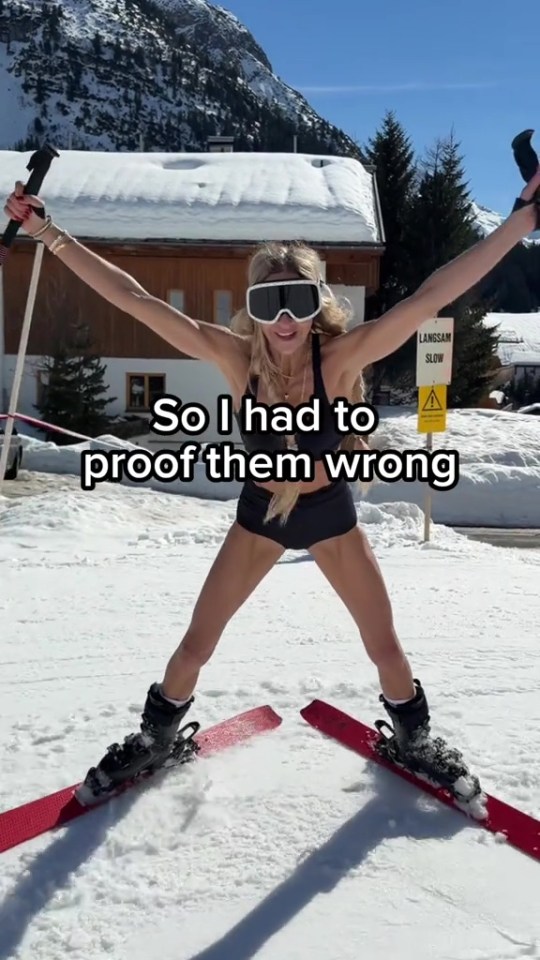 Woman in ski goggles, swimsuit and skis with arms raised, captioned "So I had to proof them wrong."