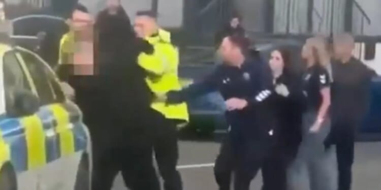Shocking moment huge brawl erupts after football match as cops tackle fans to the ground & five arrested