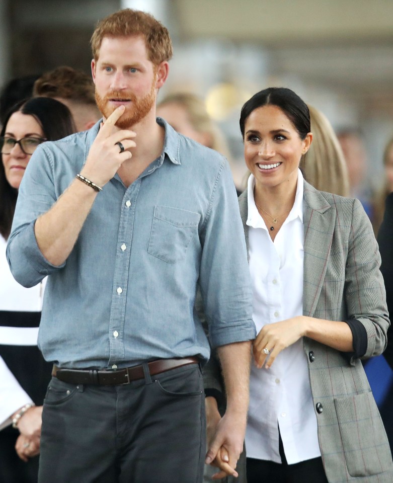 Prince Harry and Meghan, Duchess of Sussex, holding hands during their visit to Australia.