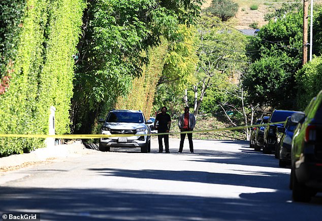 The suspect, who is described as a woman around 30 years of age, was detained by law enforcement at the scene; Yellow police tape is seen in a photo from outside the star's home