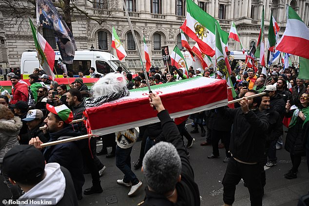 One of the protestors behind the coffin told the Mail: 'We want to show people that the Supreme Leader of the terrorist regime in Iran died. We call him (Khamenei) Moosh-Ali - it means he's a rat. A coward'