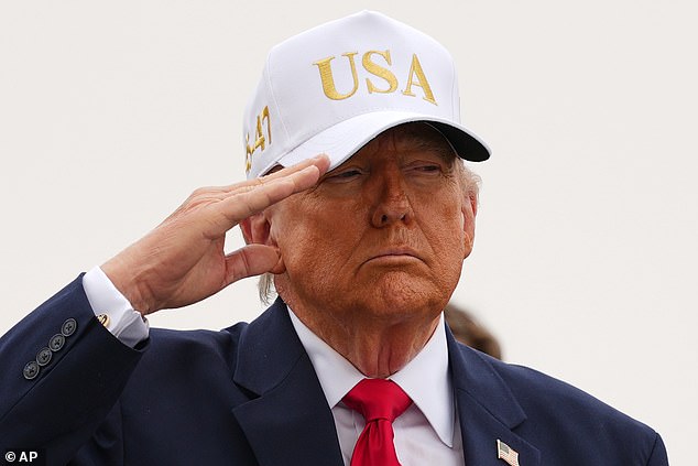 Salute: Mr Trump honours the six soldiers killed in the Gulf - a total that increased to seven last night