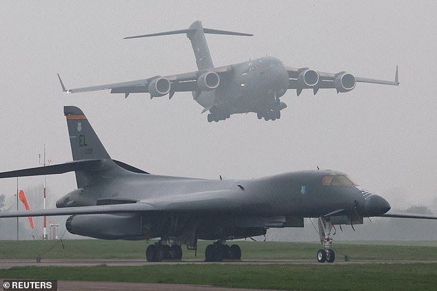 Show of power: A US Boeing C-17A Globemaster laden with missiles lands at RAF Fairford in Gloucestershire yesterday, behind a USAF B-1B Lancer long-range bomber