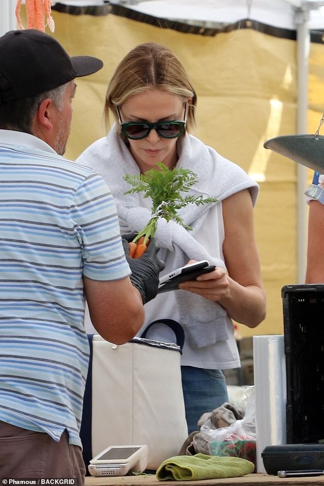 Enjoying the sunny weather, the Oscar winner browsed a selection of vegetables, including carrots