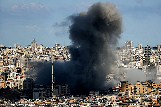 A smoke cloud erupts from the site of an Israeli airstrike on Beirut's southern suburbs on March 9