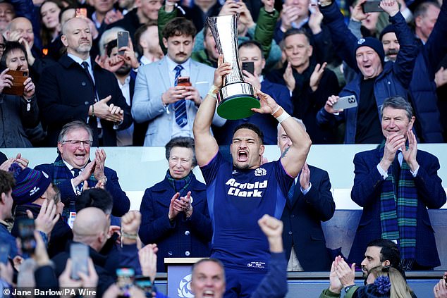 'Win the championship and he might just get that hug,' quipped one avid fan, while others suggested that the hilarious moment revealed a 'genuine affection on both sides'. Pictured: Mr Tuipulotu celebrates following the nation's historic win at Murrayfield