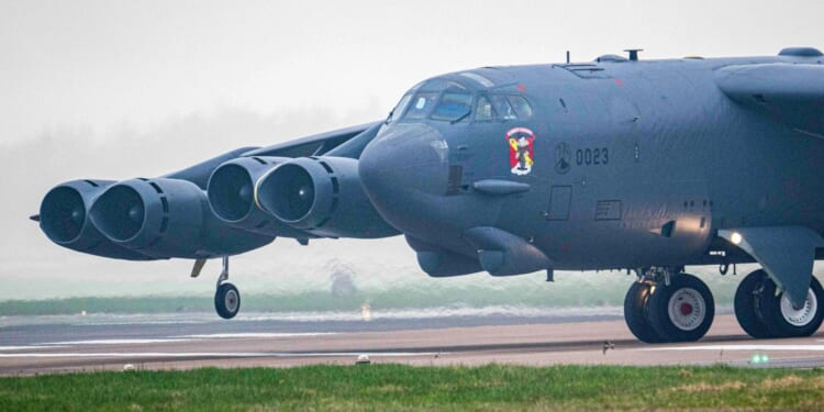 Iconic US B-52 bombers that can each carry 31 TONNES of weaponry land in Britain as Trump gathers vast Iran strike force