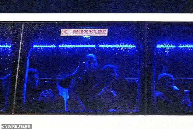 Players inside the bus filmed the protest (pictured) and at least one reportedly gave the international signal for SOS