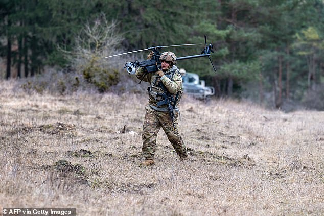 An Anduril Ghost X drone is carried by an US soldier at the Hohenfels Training Area in southern Germany on February 6, 2025. Drones, cheaper and more plentiful than in the past, are changing the face of warfare, particularly in Ukraine and Iran