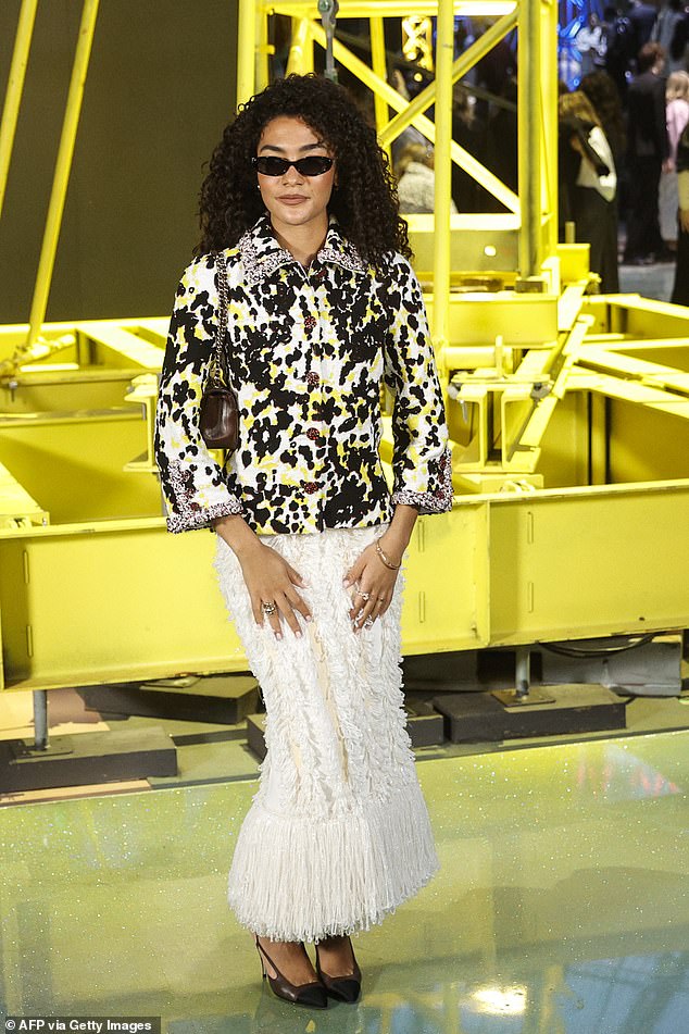 Olivia Dean, 26, looked gorgeous in a patterned blazer and textured white skirt for the fashion show