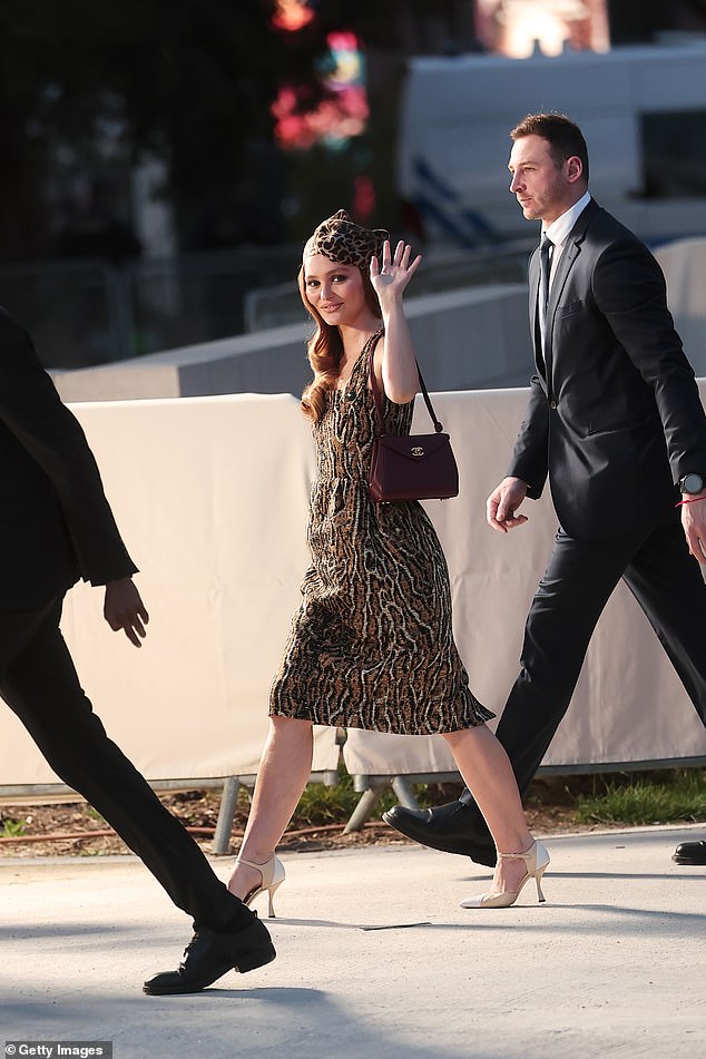 Lily boosted her height with nude heels and added a matching hat to her look
