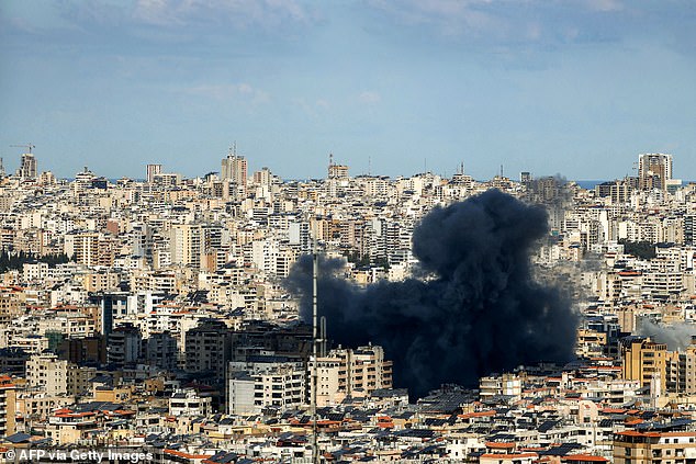 A smoke cloud erupts from the site of an Israeli airstrike on Beirut's southern suburbs on March 9