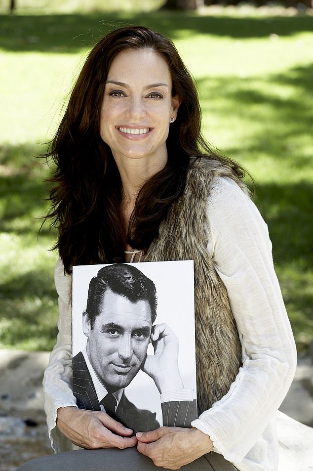 Her she is seen in Los Angeles while holding an old photo of her famous father