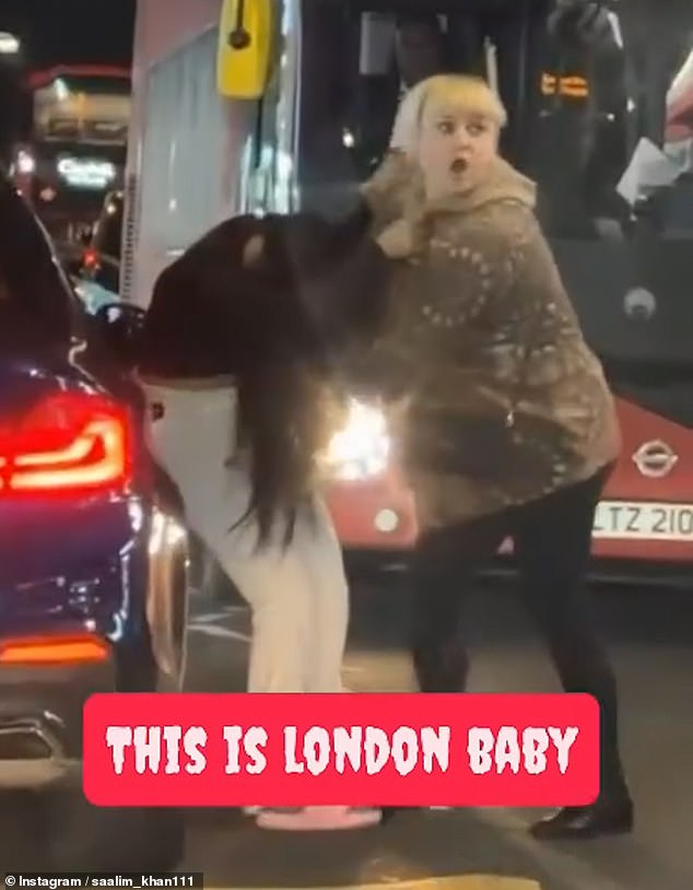 The driver drags her towards the ground when the other woman also grabs her head and continue wrestling with one another until the scrap is broken up