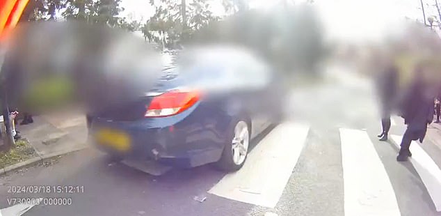 Body camera footage shows a driver narrowly missing a lollipop lady and pedestrians in Hertfordshire