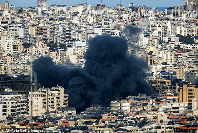 A smoke cloud erupts from the site of an Israeli airstrike on Beirut's southern suburbs on March 9