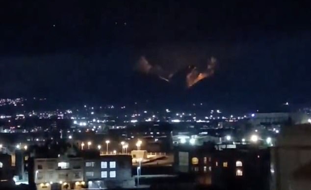 An orange flash illuminates the night sky in Tehran amid the latest wave of US-Israeli attacks proving Mr Trump's vow to 'go further' in the conflict was serious