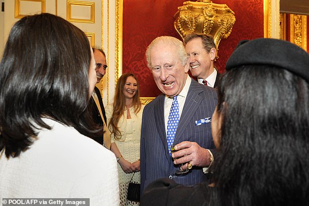 The King speaks with guests during the annual Commonwealth Day Reception on Monday