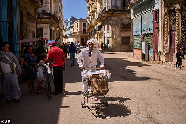 A baker hawks his baked goods through the streets of Havana, Cuba on Thursday