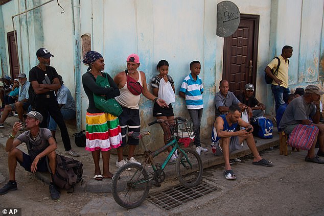 People wait their turn to buy bread during a blackout in Havana. The powercut hit two-thirds of the beleaguered communist nation and stemmed from a lack of fuel under US pressure