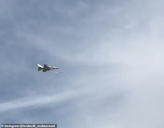 The F-16E firing what appears to be an AIM-9X Sidewinder at the drone