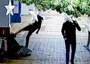 Shocking moment thug kicks homeless woman in head in sickening unprovoked attack as she sat in street