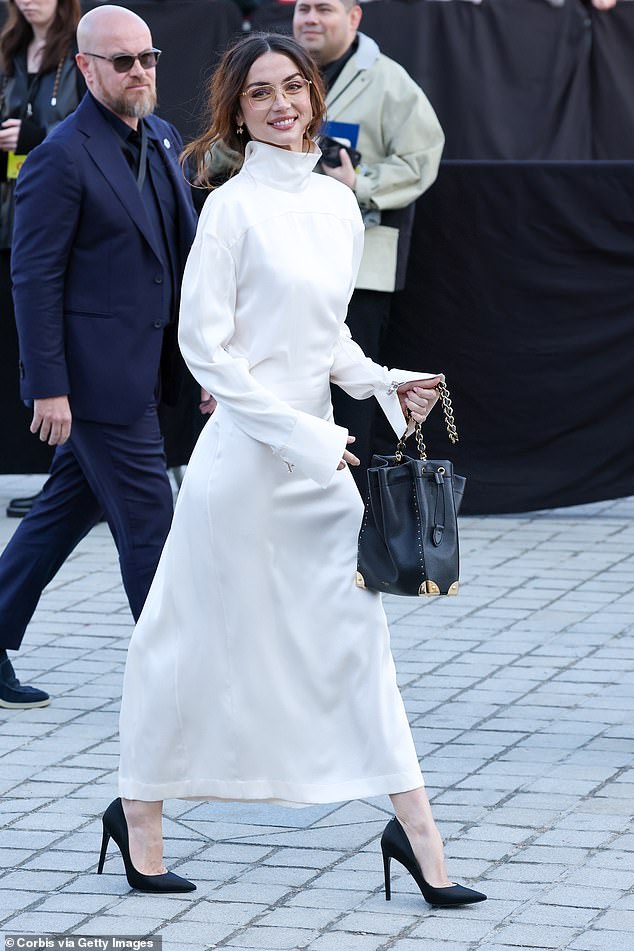 No Time To Die star Ana, 37, turned heads as she arrived in a long-sleeved white dress with a high collar