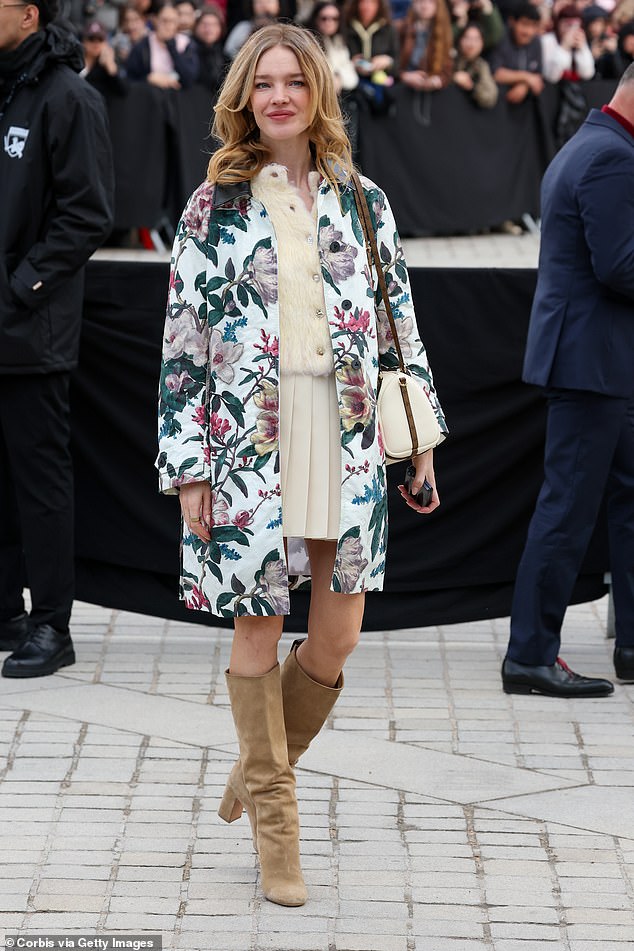 Natalia Vodianova donned a floral print jacket over a cream woolly jumper and a pleated mini skirt