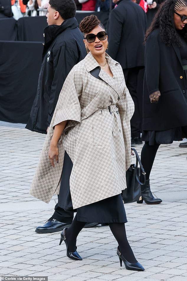 Ava DuVernay wore a trench coat with a checkered pattern over a black dress
