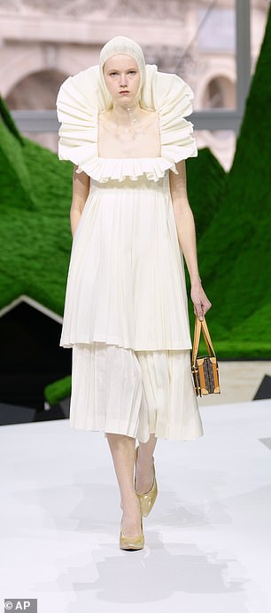 One model donned a white pleated dress with a dramatic collar and hood