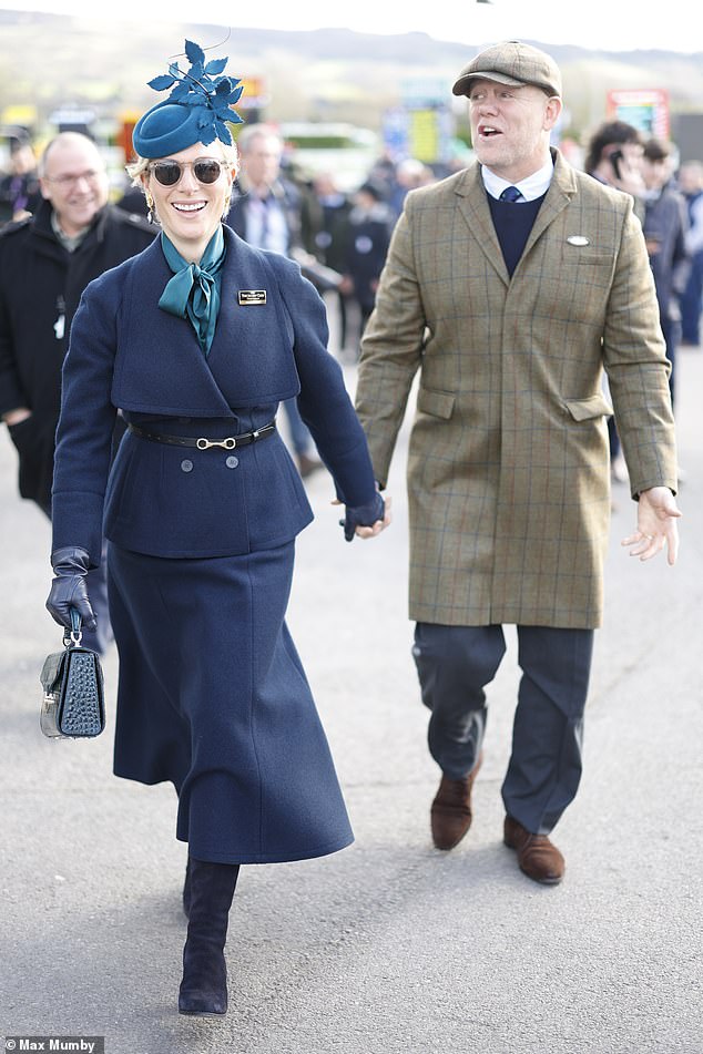Mike wore a tweed coat over a navy suit and matching tie, finishing the look with polished chocolate brown suede shoes