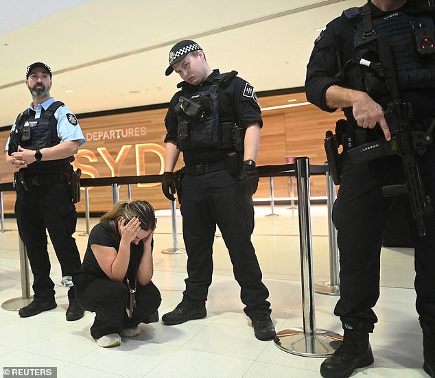 Protesters and police greeted the women at Sydney International Airport (above)