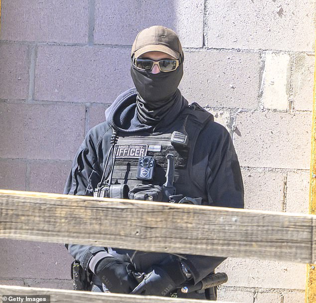 Armed security guards watched the protest from inside the Zorro Ranch property