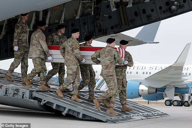 A US Army carry team moves a flag-draped transfer case containing the remains of Maj. Jeffrey R. O'Brien at Dover Air Force Base March 7, 2026 in Dover, Delaware