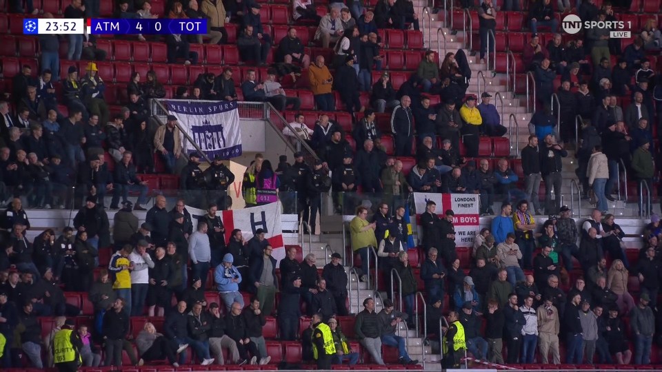 Spectators in a stadium, with a "Berlin Spurs" banner visible.