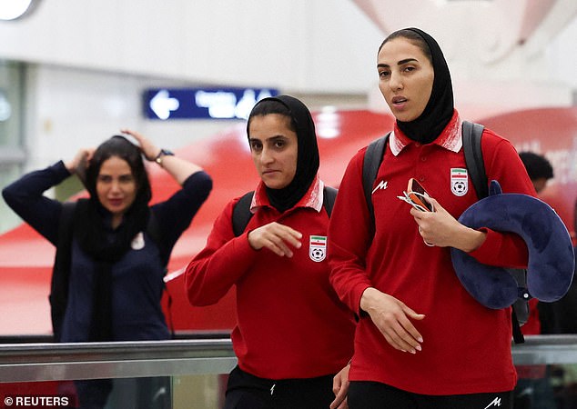 The Iranian women's football team pictured at Kuala Lumpur International Airport on Wednesday as they made their return