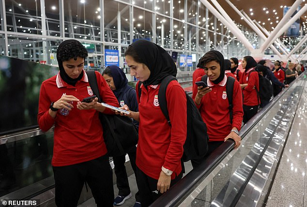 Pictured: Iranian team members arriving at Kuala Lumpur Airport on their way back to Iran, where they face possible severe reprisals for their anthem boycott