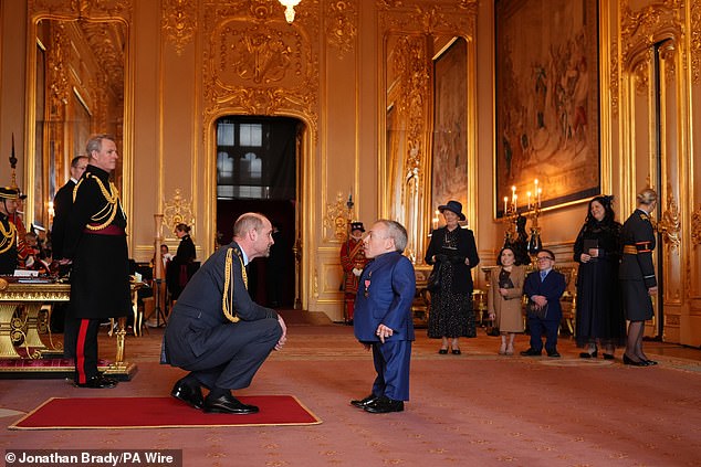 Arriving for the ceremony, Warwick was seen conversing with Prince William as he accepted the honour, with his mystery woman and his children watching on