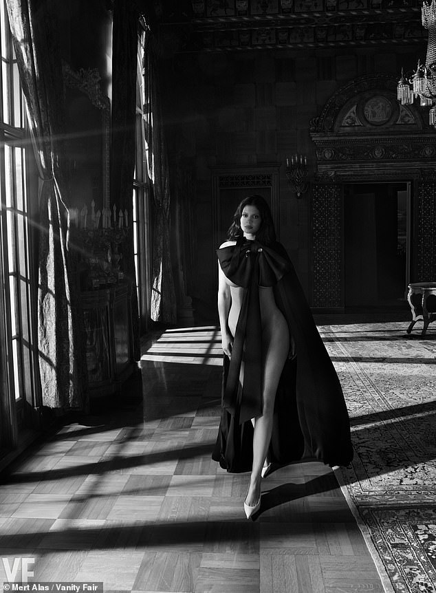 She posed naked under a bowed cape and heels for a sexy black and white photo for her raciest shoot yet as she detailed growing up in the spotlight