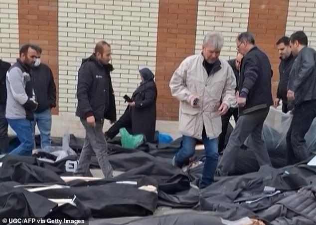 Dozens of bodies lying on the ground at the Tehran Province Forensic Diagnostic and Laboratory Centre in Kahrizak, as grieving relatives search for their loved ones