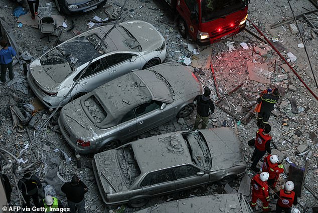 Emergency personnel work at the site of an Israeli airstrike that targeted a building in Beirut's Aisha Bakkar neighbourhood on March 11, 2026