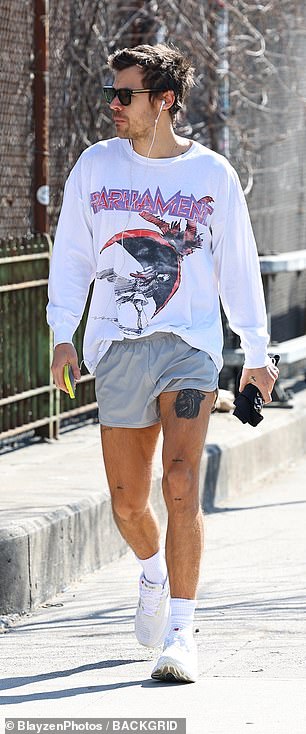 The singer, 33, threw on a graphic white long-sleeved T-shirt, shades and white running shoes