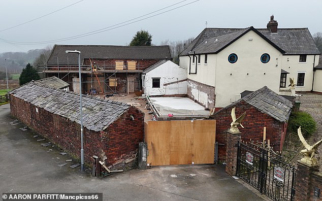 The sprawling four-bedroom property features a gated cobbled driveway, 16 stables, and a large barn, set over 15 acres of land