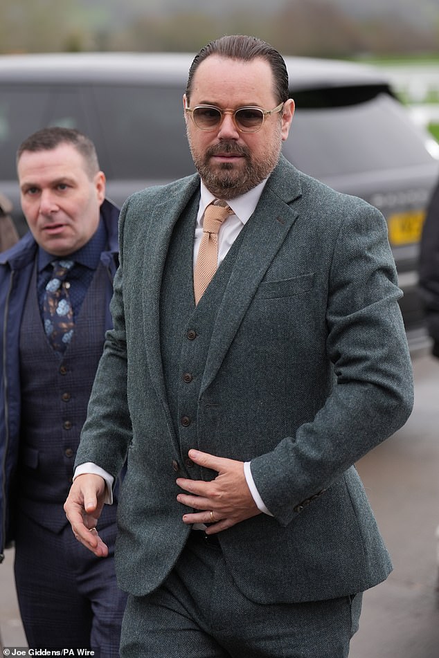 Danny too was dressed to the nines in a stylish green three piece suit paired with stylish sunglasses - despite the dreary weather