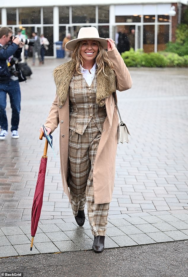 Fur-tastic! A woman dresses in a tan look, complete with a fur-lined coat and check suit